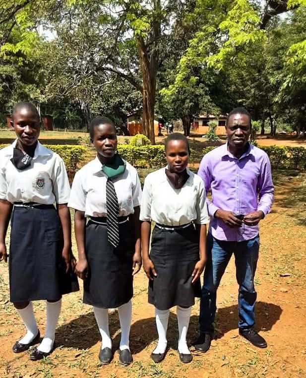 Group of students pictured with Mr. Lukoli.