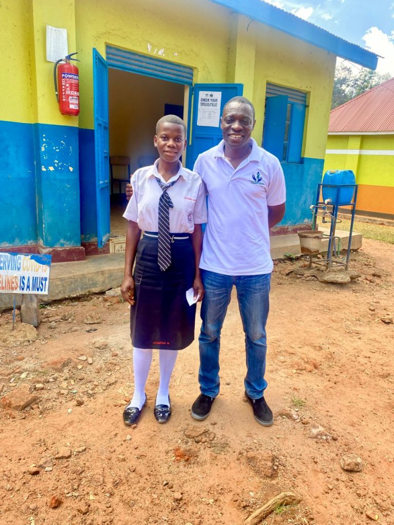 A student pictured with Mr. Lukoli.